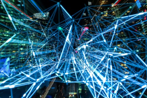 Abstract data network overlaid on a city skyline at night